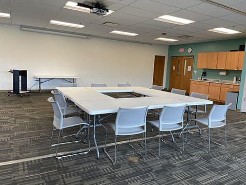 Meeting room full setup, chairs, tables, projector, etc.