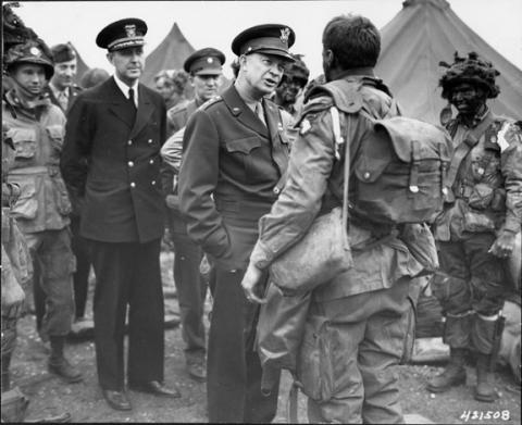 Black and White photo of General Dwight D. Eisenhower speaking to soldiers
