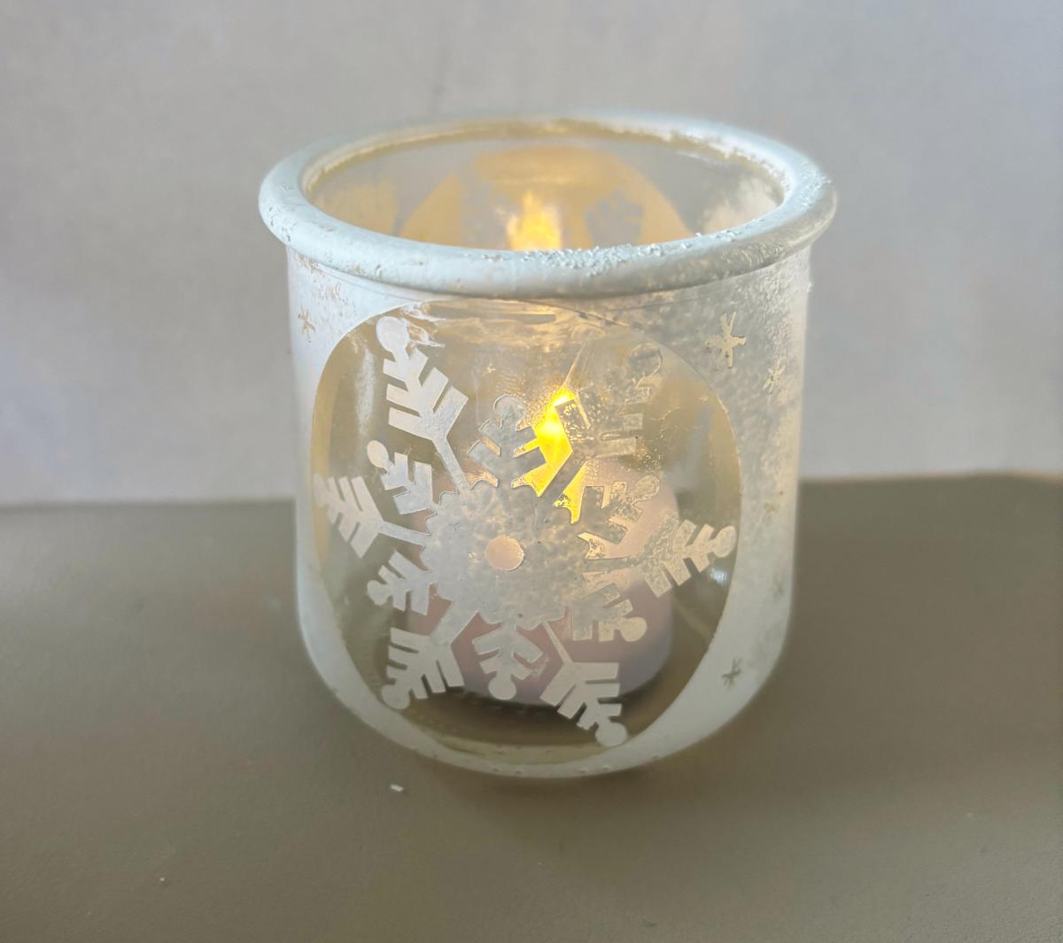 jar with white snowflake on it and small light shining inside