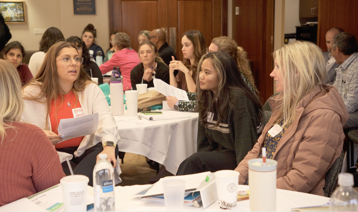 Picture of people talking at a conference. 