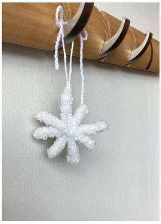 Crystal snowflake hanging from a hook